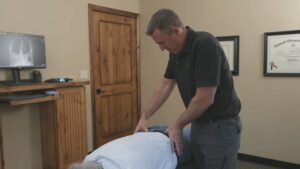 Posture evaluation followed by chiropractic adjustment