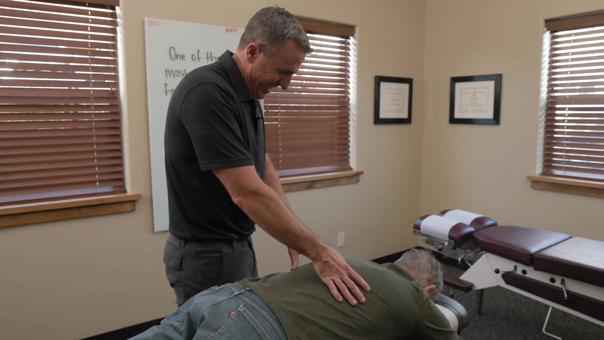 Chiropractor performing spinal adjustment to relieve back pain.