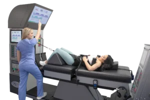 Female chiropractic assistant educating her patient about the DRX 9000 spinal decompression machine screen
