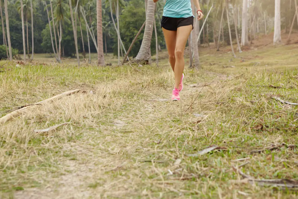 Trail runner stretching to prevent injury during outdoor run