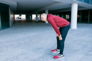 Person experiencing recurring sciatica pain in lower back and leg